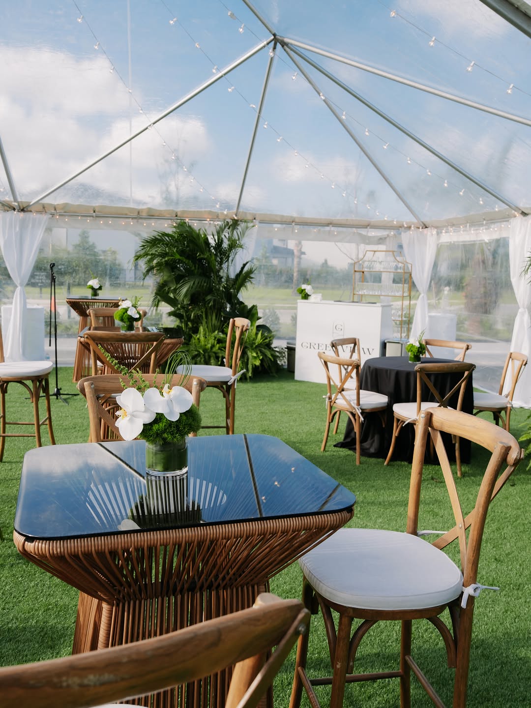 Luxury clear-tent event glowing under warm light in Miami