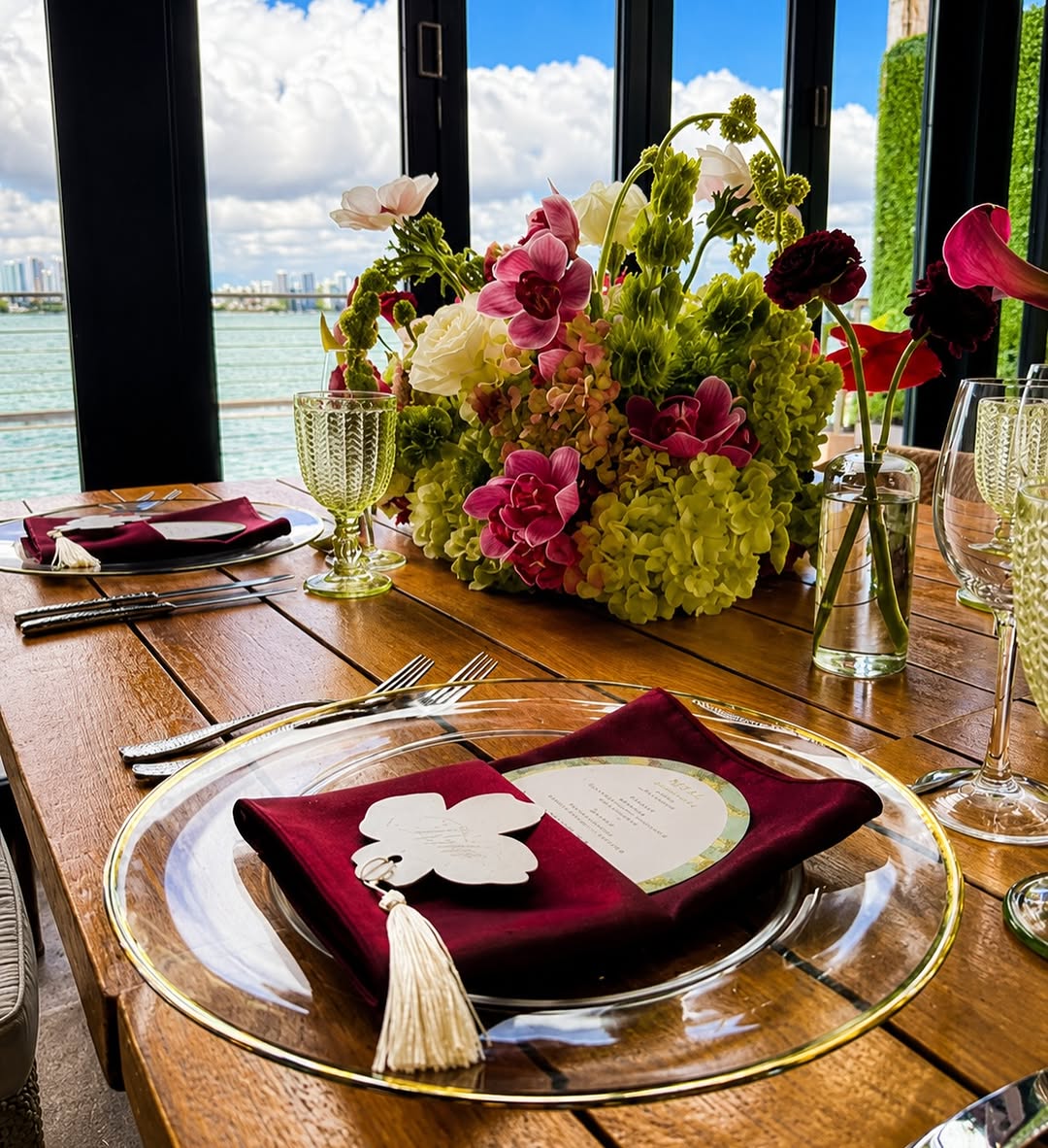 Gold-rim charger plates with burgundy napkins